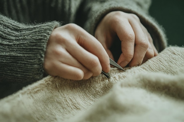 руки с иглой и ниткой